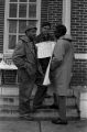 Scott B. Smith of SNCC speaking with Mike Bibler and John Davis of SCLC, in front of the Barbour County courthouse in Eufaula, Alabama.