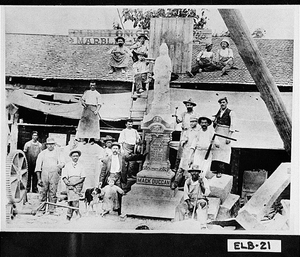 Photograph of men around monument of Mack Duccan, Elberton, Elbert County, Georgia