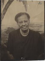 Mississippi State Sovereignty Commission photograph of Dora Edwards dressed in a black dress and wearing eyeglasses and a pearl necklace, Meridian, Mississippi, 1950s