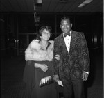 Sugar Ray Robinson posing with a woman at an event for Mayor Bradley, Los Angeles, 1974