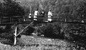 Unidentified group of women. Child wading in water