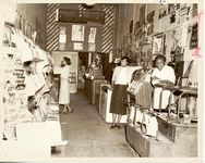 Mississippi State Sovereignty Commission photograph of A. T. Armstrong and two unidentified African American women in Farish Street Newsstand and Studio in Jackson, Mississippi, 1950s