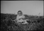Baby sitting in field