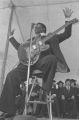 B. B. King: New Haven, Conn. Yale University Graduation. B. B. King at podium, performing at graduation ceremony (BKP 26-77-5/15)