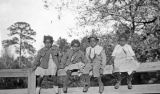 Four African American children sitting on a fence in Wilcox County, Alabama.