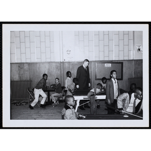 A Group of boys hanging out and playing pool games