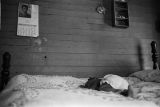 Baby asleep on a bed in the home of Percy Jones, Jr., on Clayton Alley in Montgomery, Alabama.