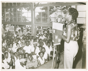 WANN broadcast of Sarah Vaughan at Carr's Beach, August, 1956, with fans standing attentively while she sings.] [Black-and-white photoprint