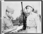 [Oliver W. Harrington, of New York City, artist correspondent, sketching Anti-aircraft Section Chief Sgt. Carl K. Hilton, of Pine Bluff, Arkansas, who is with the Fifth Army in Italy]