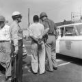 Firemen spraying a civil rights demonstrator with a hose during the Children's Crusade in downtown Birmingham, Alabama.