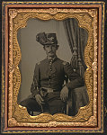 [Unidentified soldier in Union uniform and Hardee hat with ostrich feather holding sword]