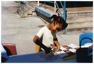 Young Girl Cutting Magazine Page