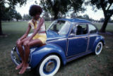 Woman sitting on Volkswagen automobile