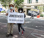 Joe and Arlo Gannon pose with a Juneteenth sign about a block from the White House on Juneteenth, a few days after the Black Lives Matter Protest in Washington, D.C.