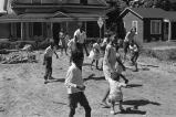 Children playing in vacant lot.