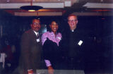 Robert A. Wild, S.J., poses with members of the Ethnic Alumni Assocation, 2001