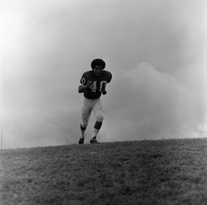 Football player running with fists, 5