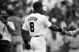 Bo Jackson shaking hands with a man during a Birmingham Barons baseball game in Birmingham, Alabama.