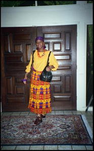 Woman in Yellow in Front of Doors