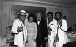 Frankie and Doug Bell posing with musicians, Los Angeles, 1986