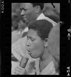 Unidentified woman, most likely a Black community leader or activist, speaking during Black student rally in Franklin Park