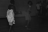 Viola Bradford learning a traditional African dance in a gymnasium, probably in Montgomery, Alabama..