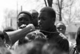 Young man speaking into a bullhorn during a student demonstration at Miles College in Birmingham, Alabama, after the death of Martin Luther King Jr.