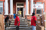 Kendall and Terrence (in red) distributing donated boxes of bread to passersby. Saint James Social Services Corporation, 604 Martin Luther King Blvd., Newark