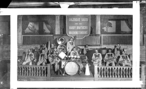 Coleridge Davis and his Hardy Brothers Washingtonians band, showing drums in center, with banner in the back : acetate film photonegative.