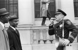 Fred Shuttlesworth and other civil rights demonstrators confronting a police officer during a protest march in downtown Birmingham, Alabama.