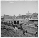 [Nashville, Tenn. Railroad yard and depot with locomotives; the Capitol in distance]