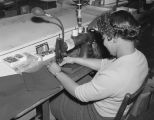 Woman hemming a pair of pants at Madison Avenue Cleaners at 330 Madison Avenue in Montgomery, Alabama.