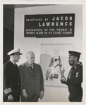 Artist Jacob Lawrence, with United States Coast Guard Captain Joe S. Rosenthal and photographer Carl Van Vechten, at his painting exhibition, "Paintings by Jacob Lawrence: Migration of the Negro & Works Made in the U.S. Coast Guard," in New York City, 1941