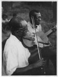 [Stavin' Chain playing guitar and singing the ballad "Batson" accompanied by a musician playing violin, Lafayette, La.]