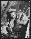 Fort Knox. Negro mechanics. Transmission job on an army truck at Fort Knox, Kentucky. This Negro soldier, who serves as truck driver and mechanic, plays an important part in keeping the army's transport fleets in service