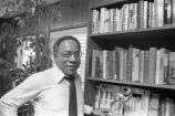 Alex Haley: Seated at bookcase, director's chair (AHP 2-79-10 #64)