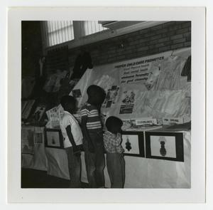 Children Looking at a Child Care Display