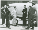 Thumbnail for A white P-80 pilot standing next to a plane and speaking to African American Marcus H. Ray, Civilian Aide to the Secretary of War, as four other African American men look on and listen, Army Air Forces Wright Field, Dayton, Ohio