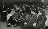 High school students sit in assembly hall