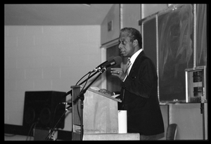 James Baldwin lecturing at UMass Amherst Baldwin standing at a podium with microphones