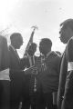 Fred Shuttlesworth, Ralph Abernathy and others talking in the street at Martin Luther King, Jr.'s funeral.