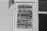 James "Son" Thomas and Joe Cooper in Leland, Mississippi. Bar, shoeshine parlor, promotional posters. (JTP 5-76-3)