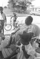 Thumbnail for Woman and children in the dirt yard in front of a house in Newtown, a neighborhood in Montgomery, Alabama.