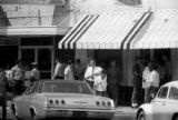 Protestors carrying signs while marching past The Hobby Shop in downtown Prattville, Alabama, during a civil rights demonstration.