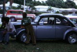 Male group sitting on Volkswagen automobile