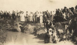 African American woman being baptized in a creek.