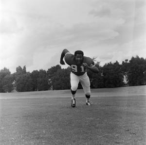 Football player running on the field, 76