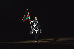 Both this flag emphasizing African Americans' history and the traditional U.S. colors were unfurled prior to the competition at the Martin Luther King, Jr., African-American Heritage Rodeo of Champions, one of the National Western Stock Show events in Denver, Colorado