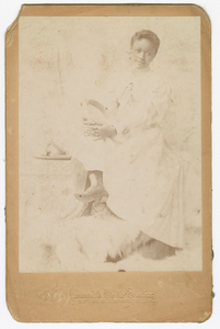 Thumbnail for Photograph of a woman sitting with her legs crossed