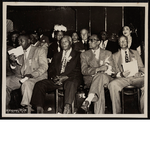 Platform guests sitting at convention session